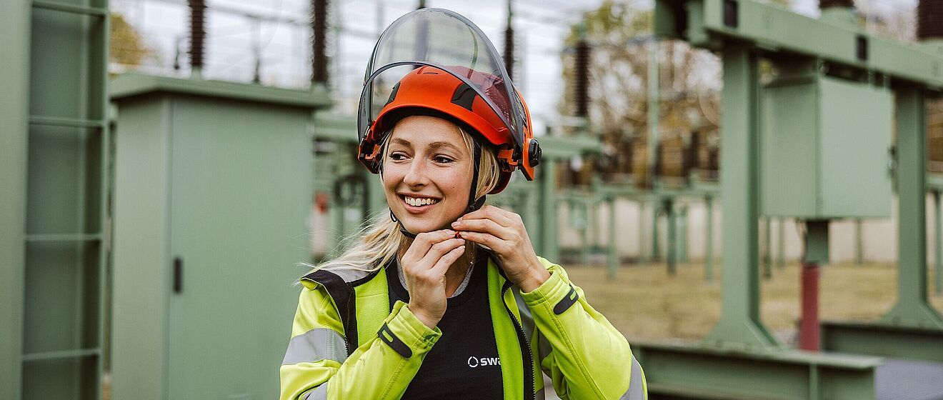 Frau mit Helm in der Netzeanlage. Weiterverlinkung zu swa Karriereseite