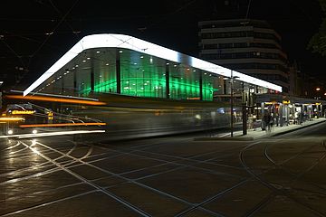 Augsburger Königsplatz bei Nacht. Zu sehen ist das beleuchtete Kundencenter und Bahnsteige. - Ein Klick auf das Bild führt zur vergrößerten Fotoansicht.