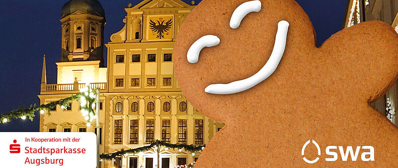 Lachender Lebkuchen vor dem Rathaus in Augsburg. Links ist das Logo der Sparkasse und rechts das Logo der swa